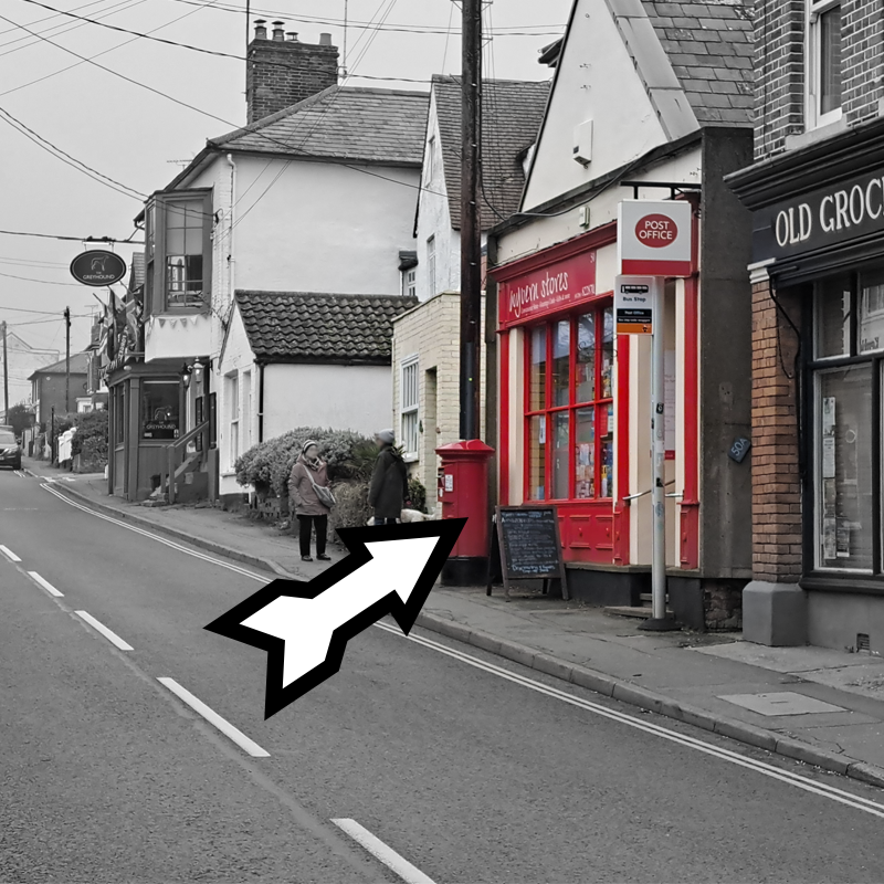 A view looking up Wivenhoe High Street from the railway bridge as you come out of Station Road. Visible is the Post Office